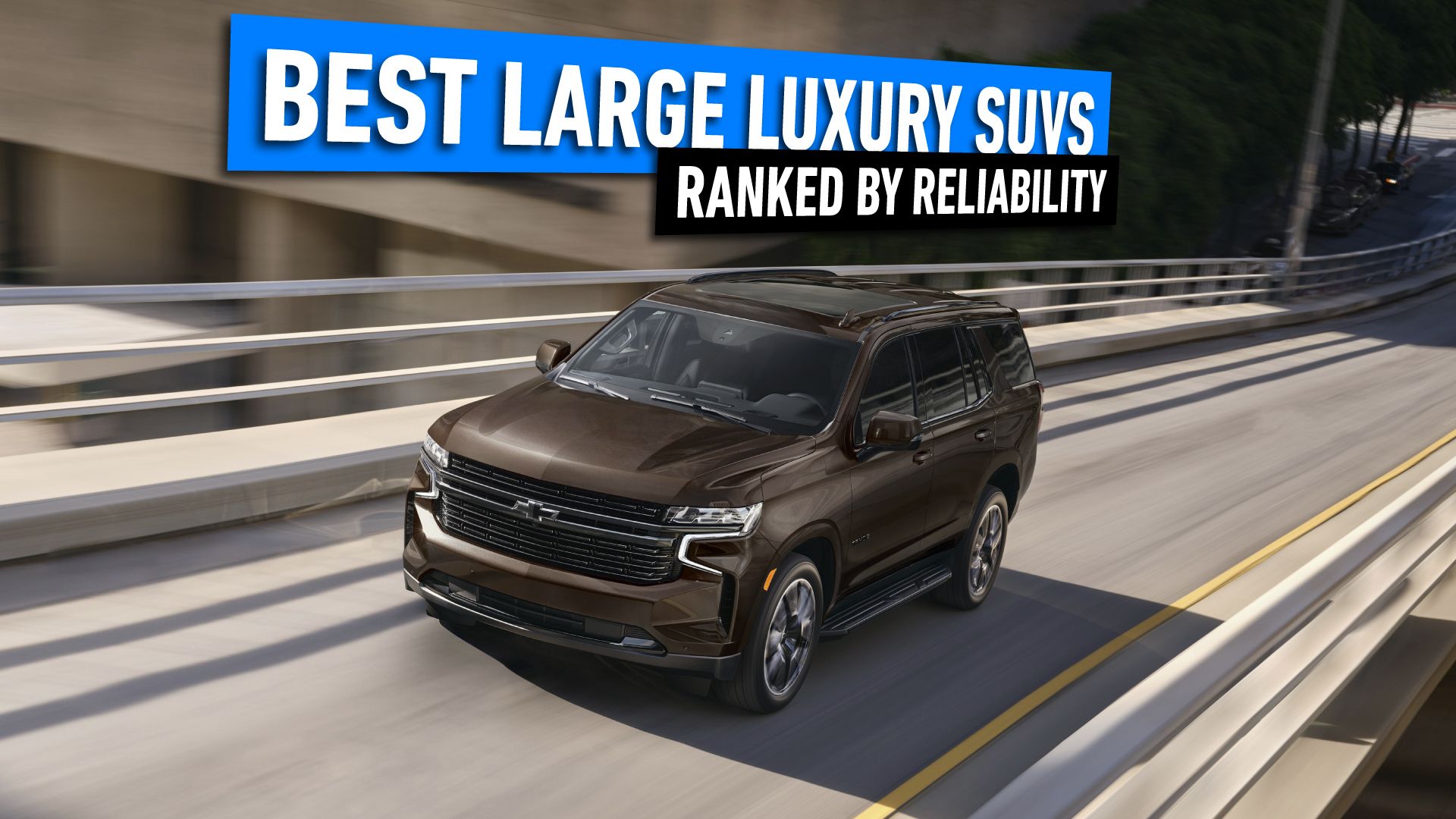 2024 Chevrolet Suburban in brown driving on a single lane road in the city