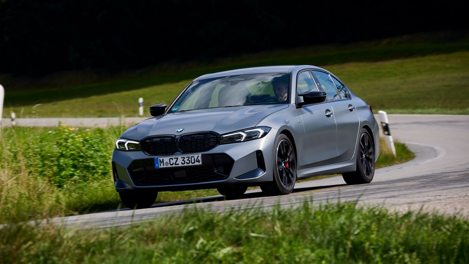 2024 BMW M340i XD front 3/4 action shot making a right turn