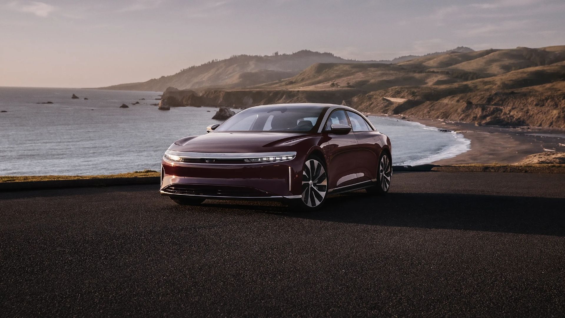 2024 Lucid Air Grand Touring in Zenith Red parked at a beach