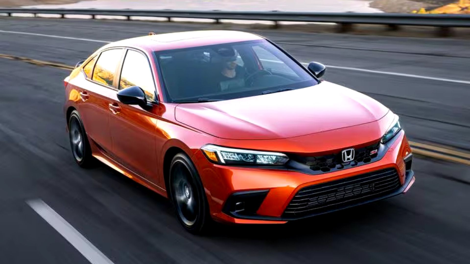 2024 Honda Civic SI Sedan in orange Posing on highway