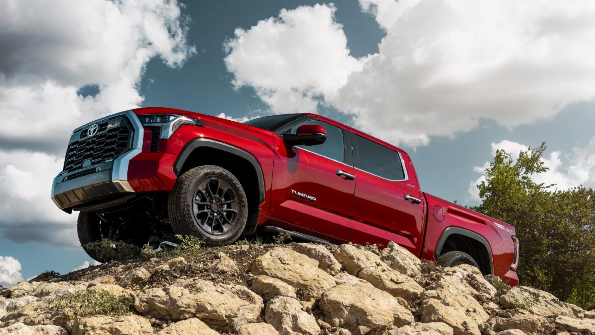 2024 Toyota Tundra Limited In red Posing on top of rocks
