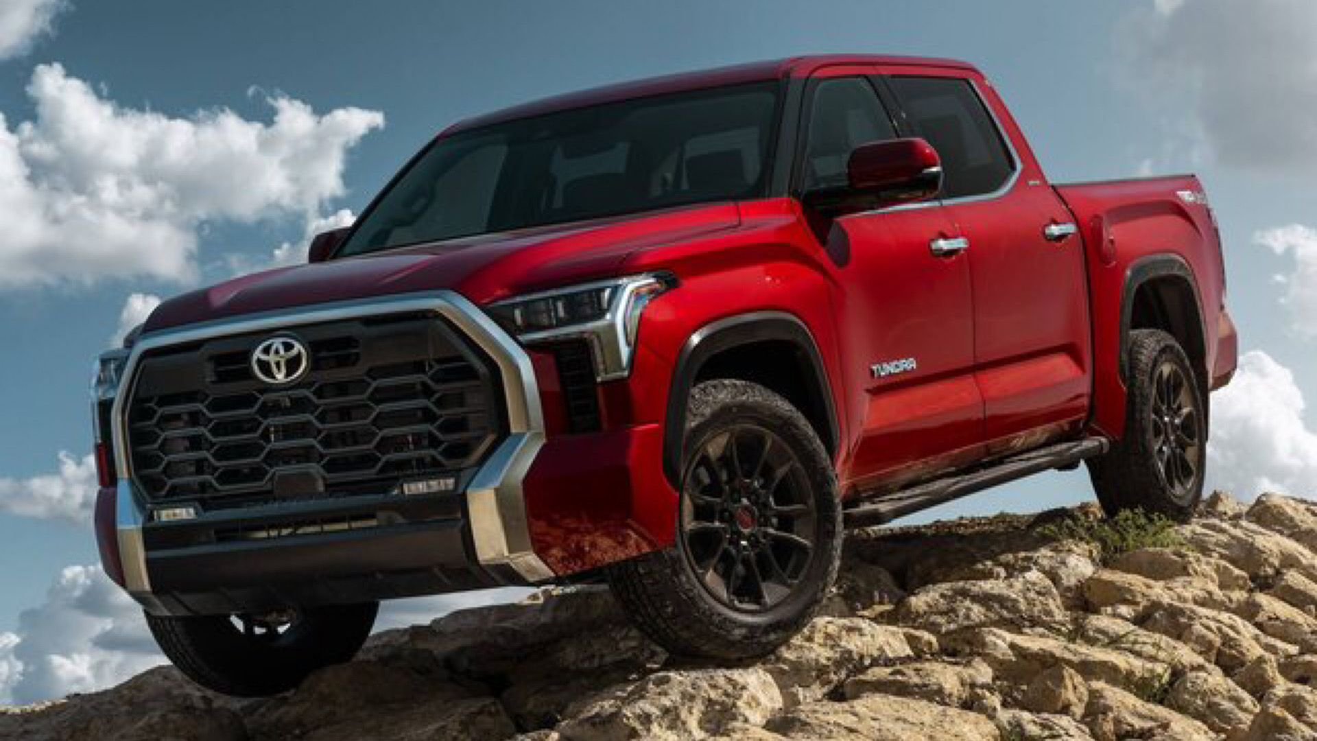 2024 Toyota Tundra SR In red Posing on top of rocky terrain