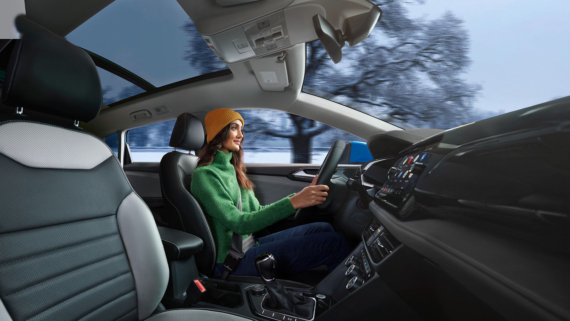 2024 Volkswagen Taos interior and woman driving