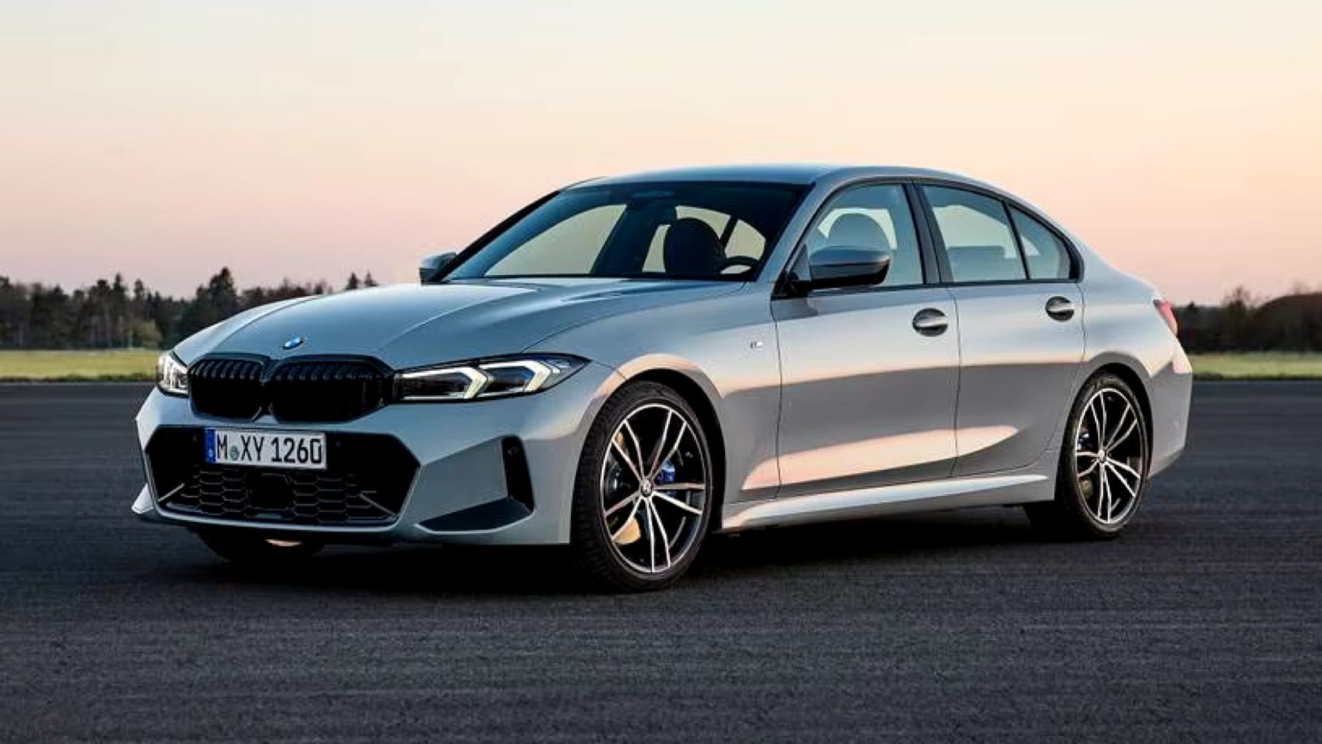 2024 BMW 330i Sedan posing on tarmac road With countryside in background