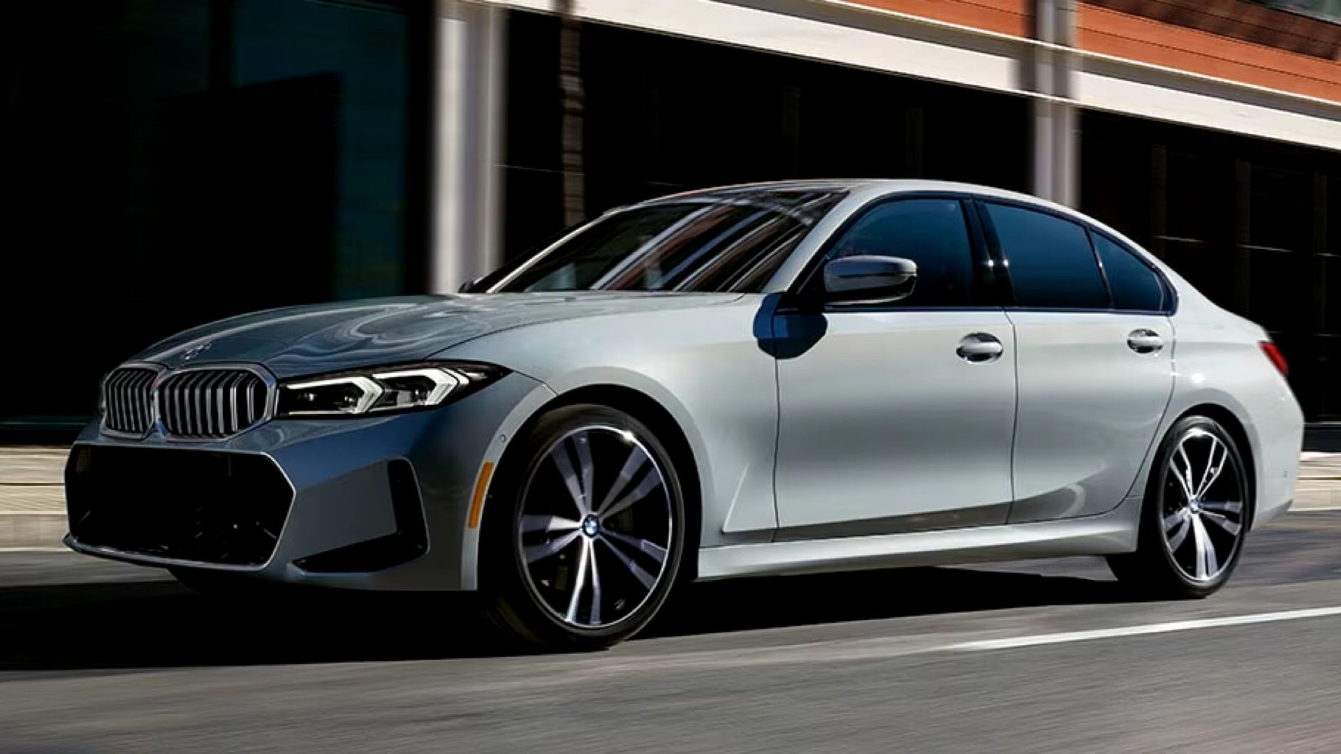 2024 BMW 330i Sedan in silver Driving on city street