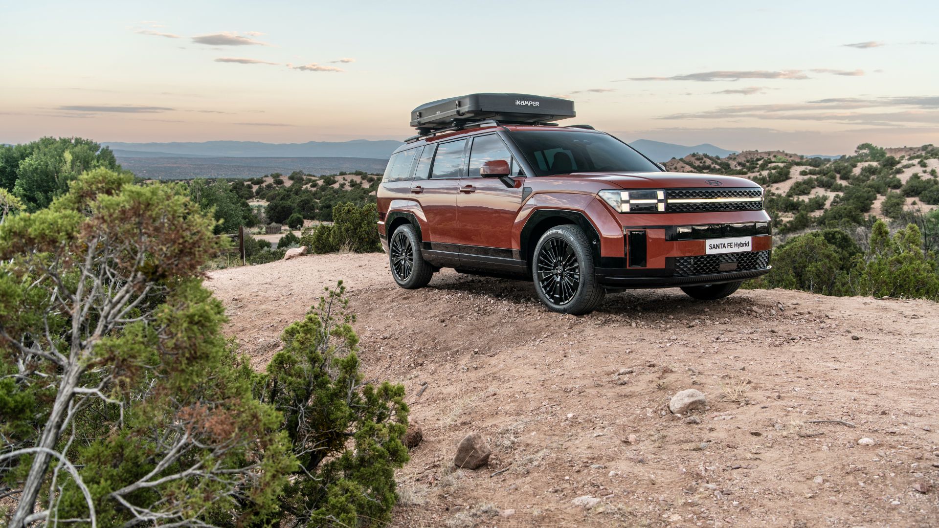 2024 Hyundai Santa FE Hybrid in a desert terrain parked sideways.