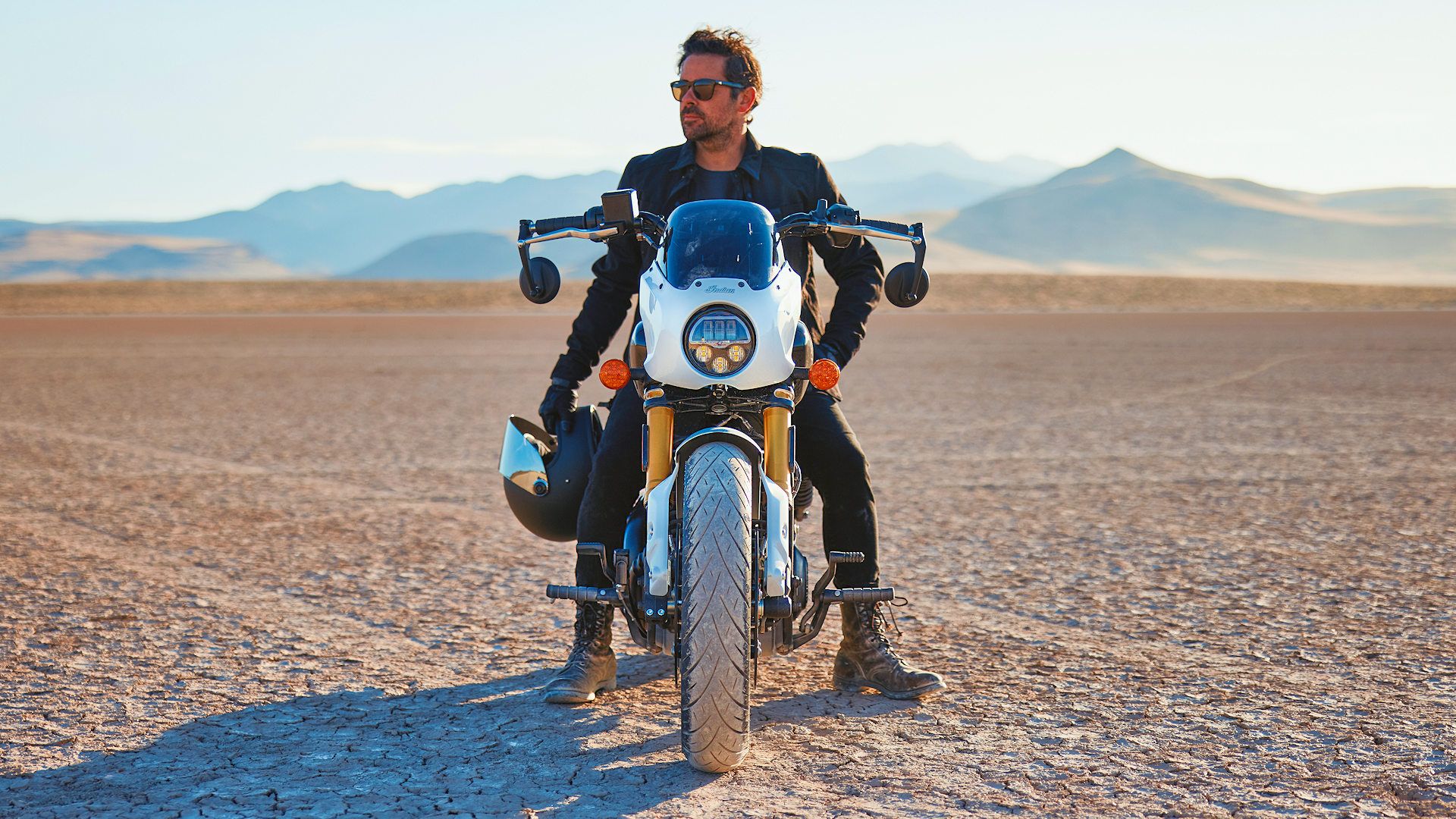 Rider sitting on a 2025 Indian 101 Scout in the desert