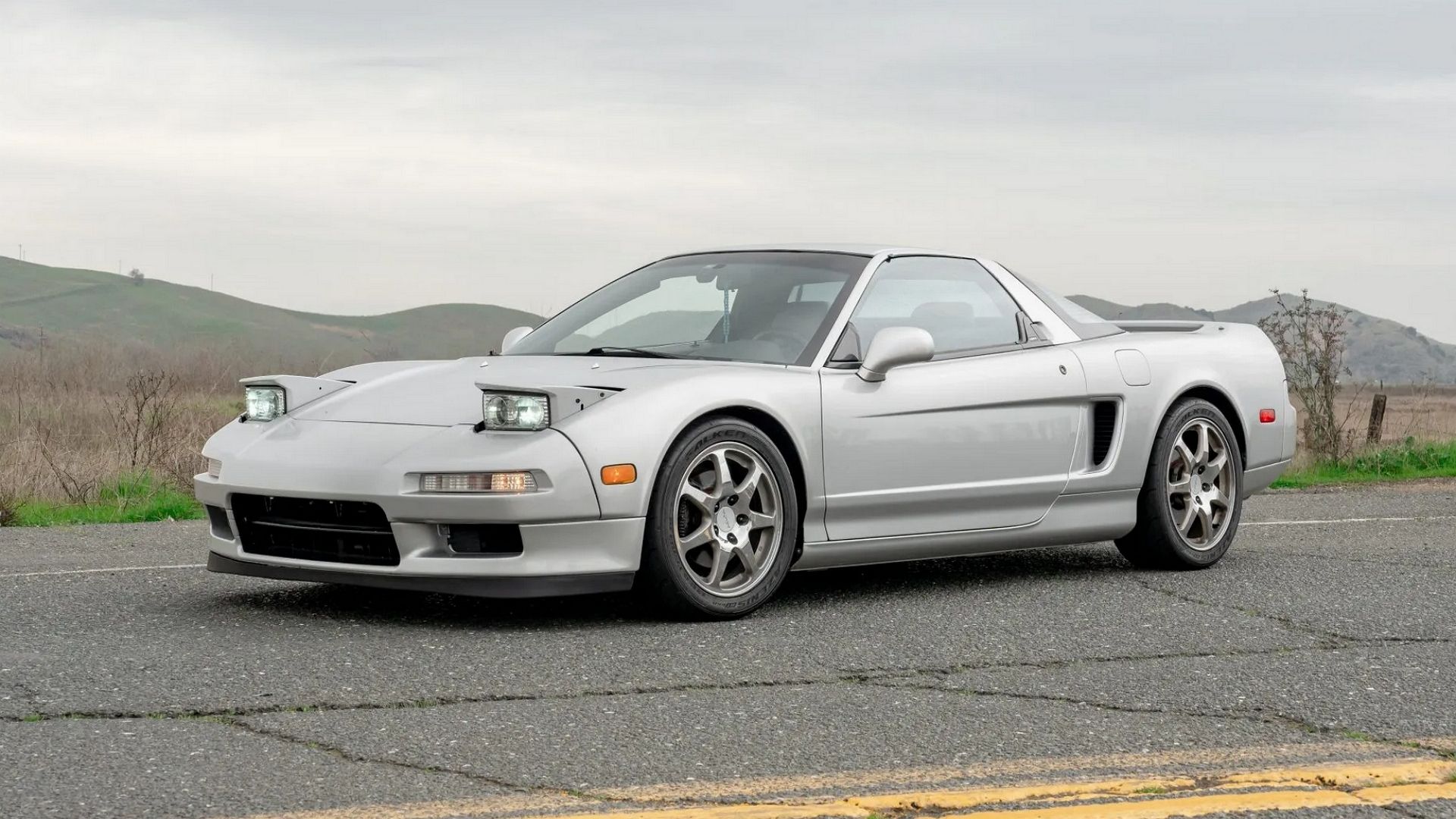 A front 3/4 shot of a Silver 1993 Acura NSX.