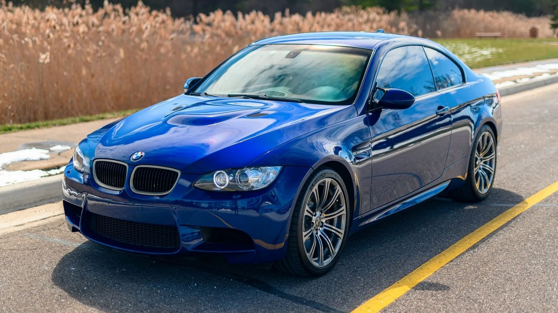 A front 3/4 shot of a Blue 2009 BMW M3 Coupe.