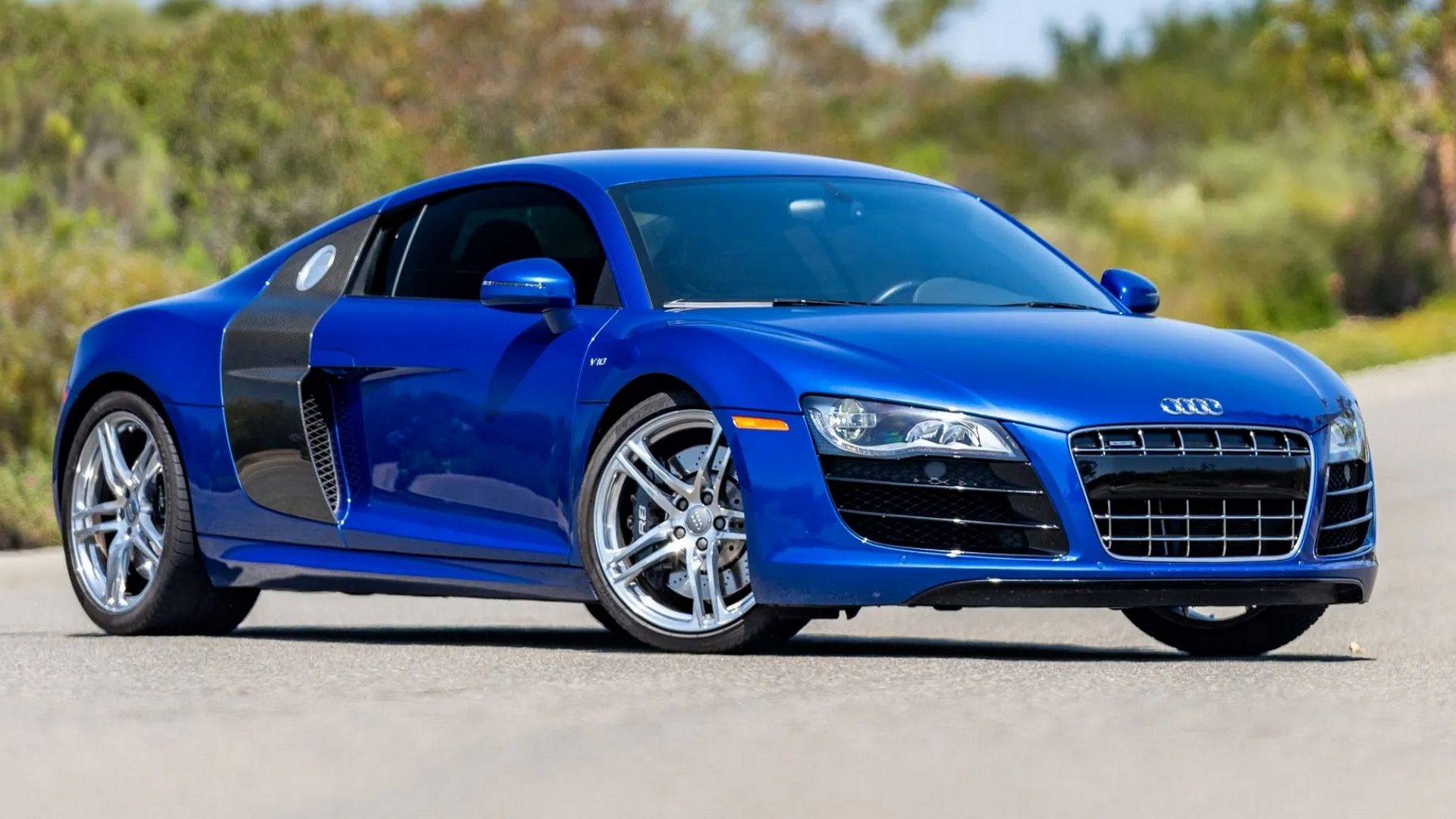 A front 3/4 shot of a Blue 2012 Audi R8 Coupe.