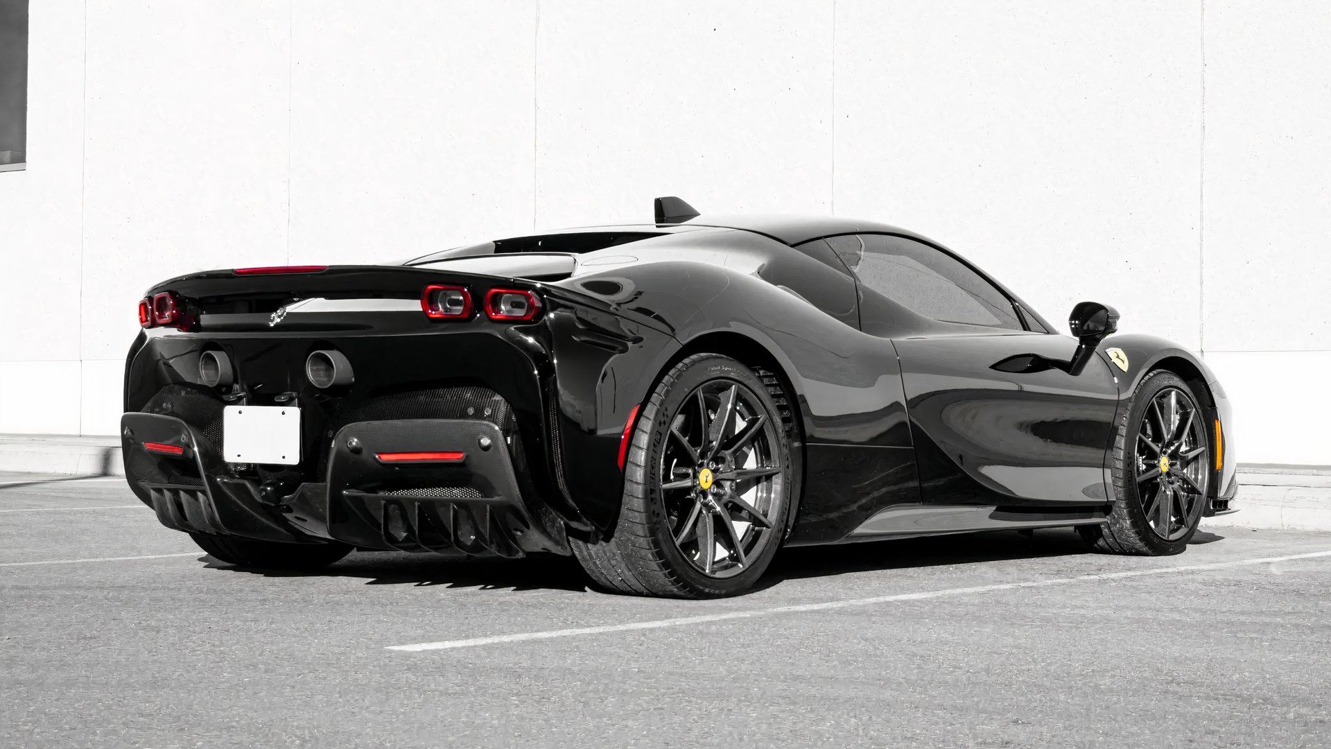 2024 Ferrari SF90 Stradale in black rear 3/4 shot