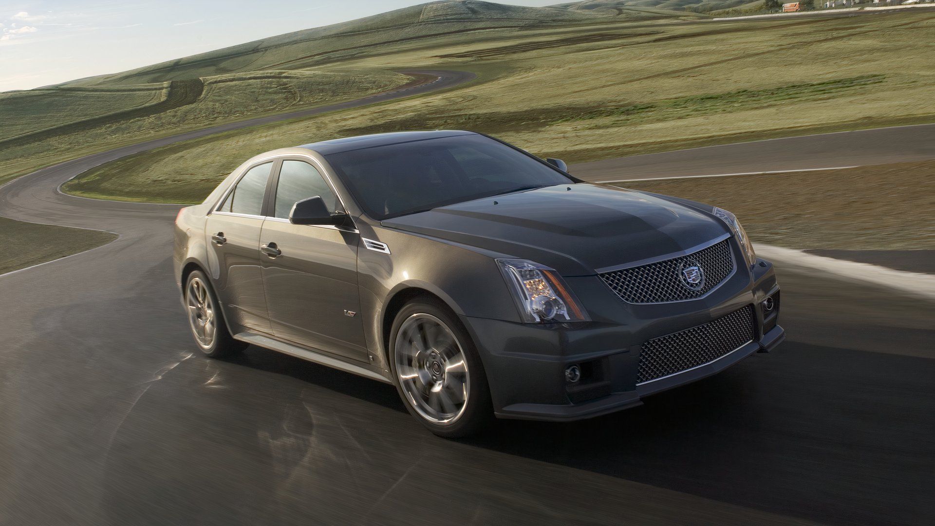 Sedan cinza 2012 Cadillac CTS-V dirigindo na pista