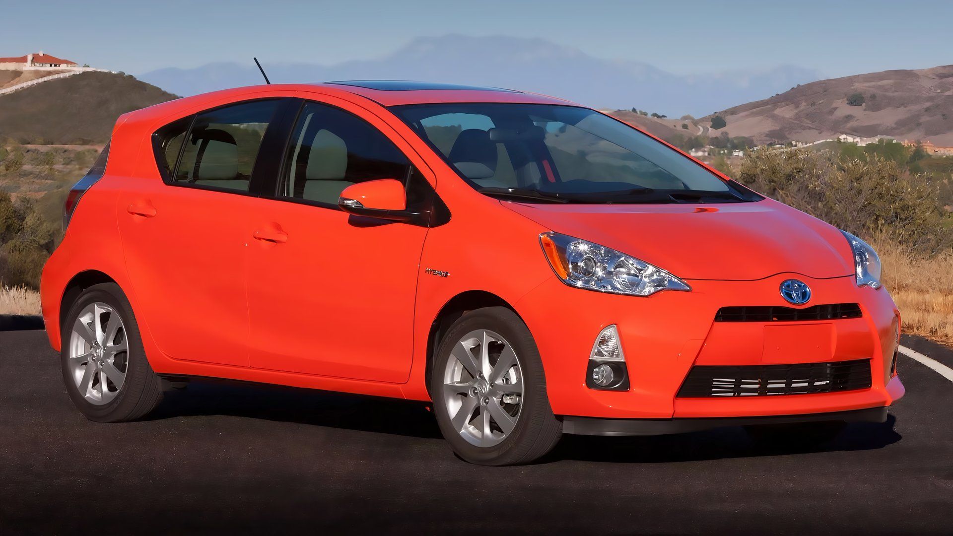 An Orange 2012 Toyota Prius C Parked