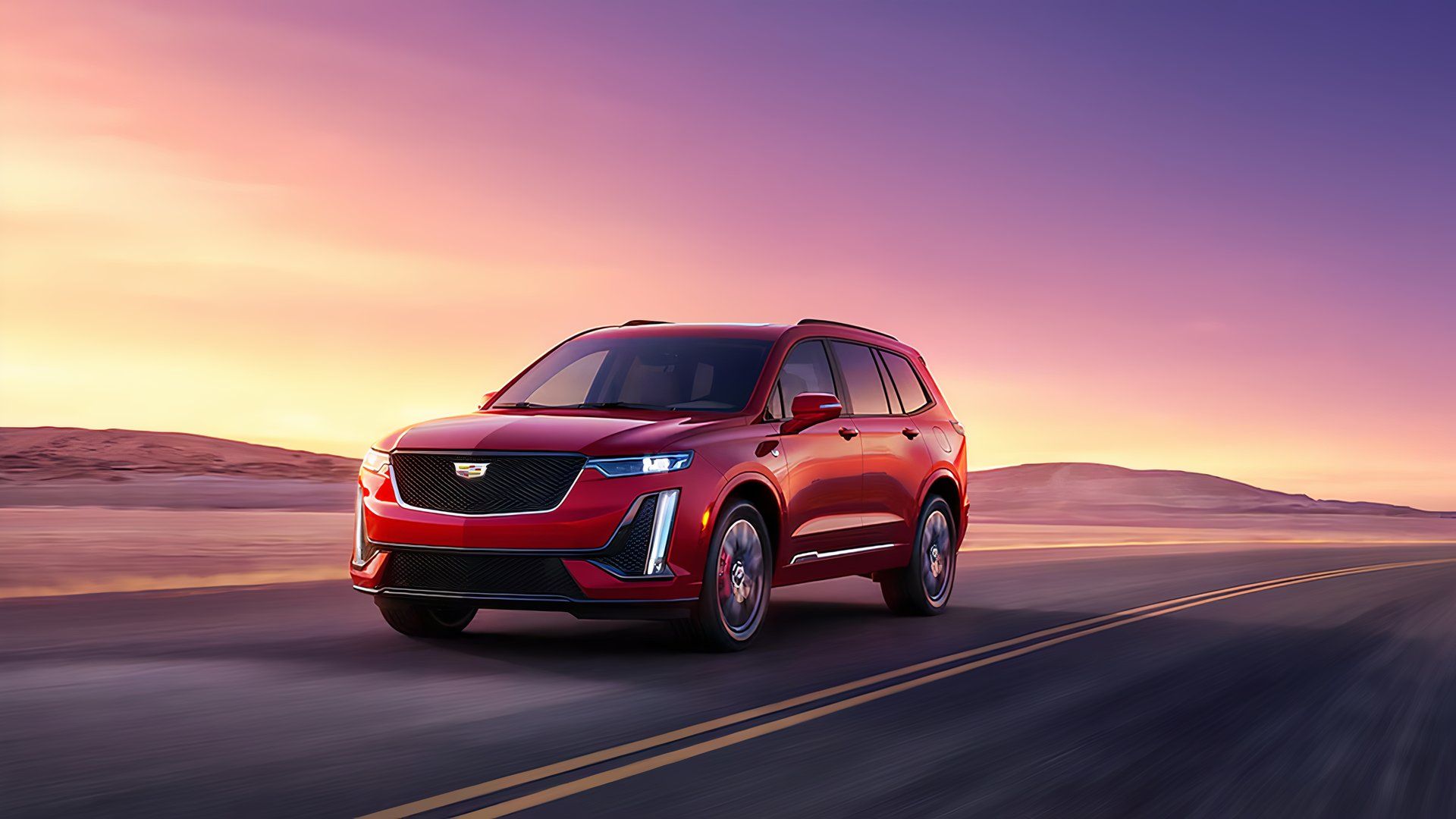 Um Cadillac XT6 vermelho 2024 dirigindo