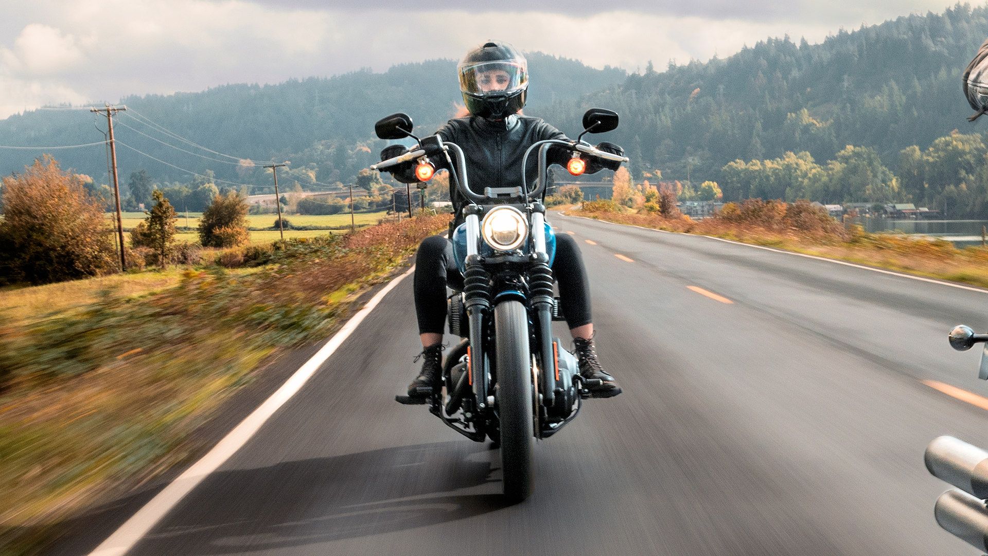 Head-on shot of a 2024 Harley-Davidson Street Bob cruising on the road
