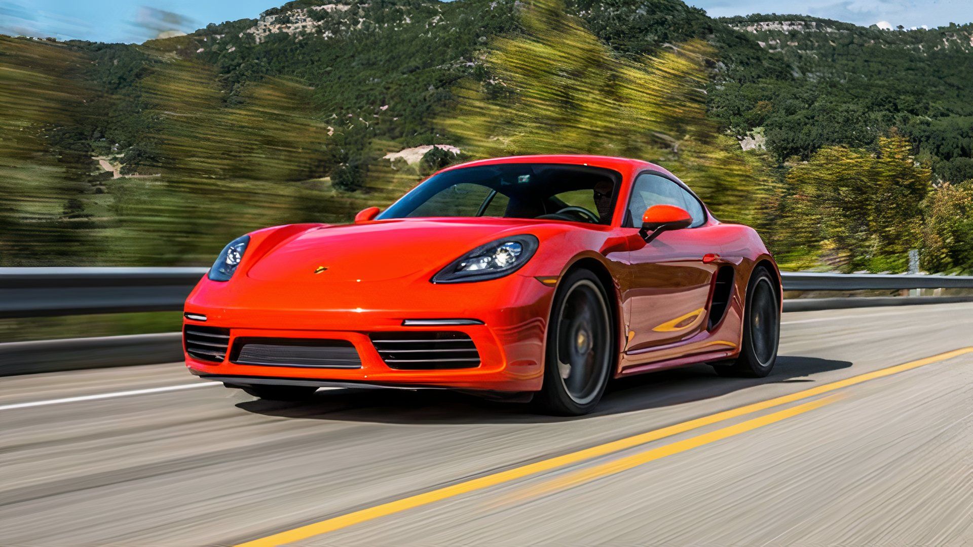 Porsche 718 Cayman S Coupe 2023 em vermelho Dirigindo em estrada rural