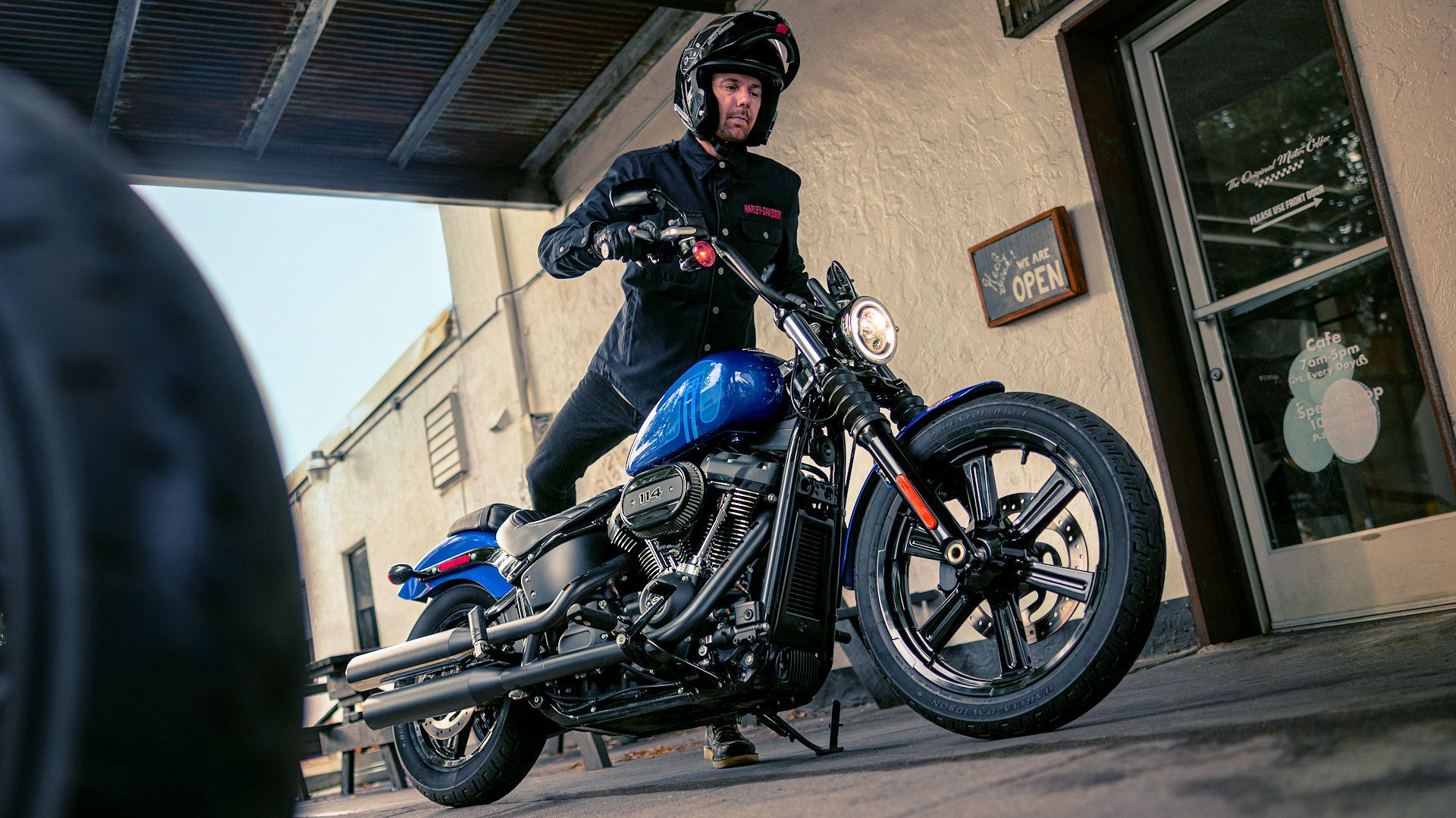 Rider mounting a 2024 Harley-Davidson Street Bob