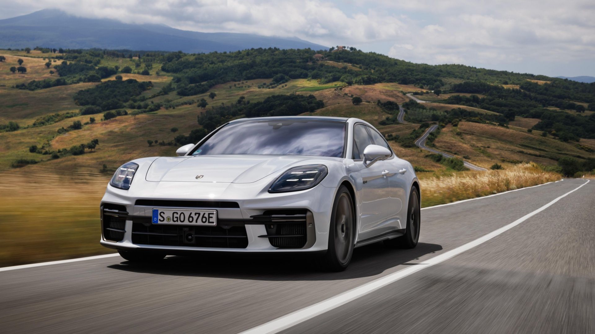 White 2025 Porsche Panamera S E Hybrid Driving Front Three Quarter