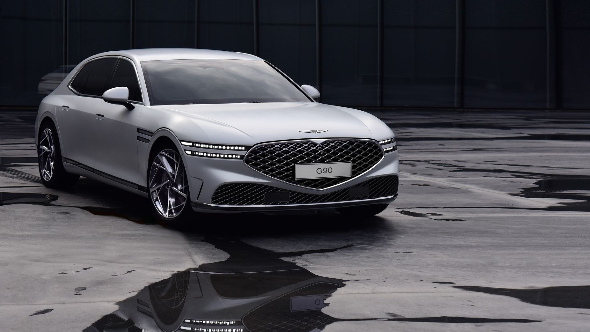 2024 Genesis G90 in silver posing in parking lot