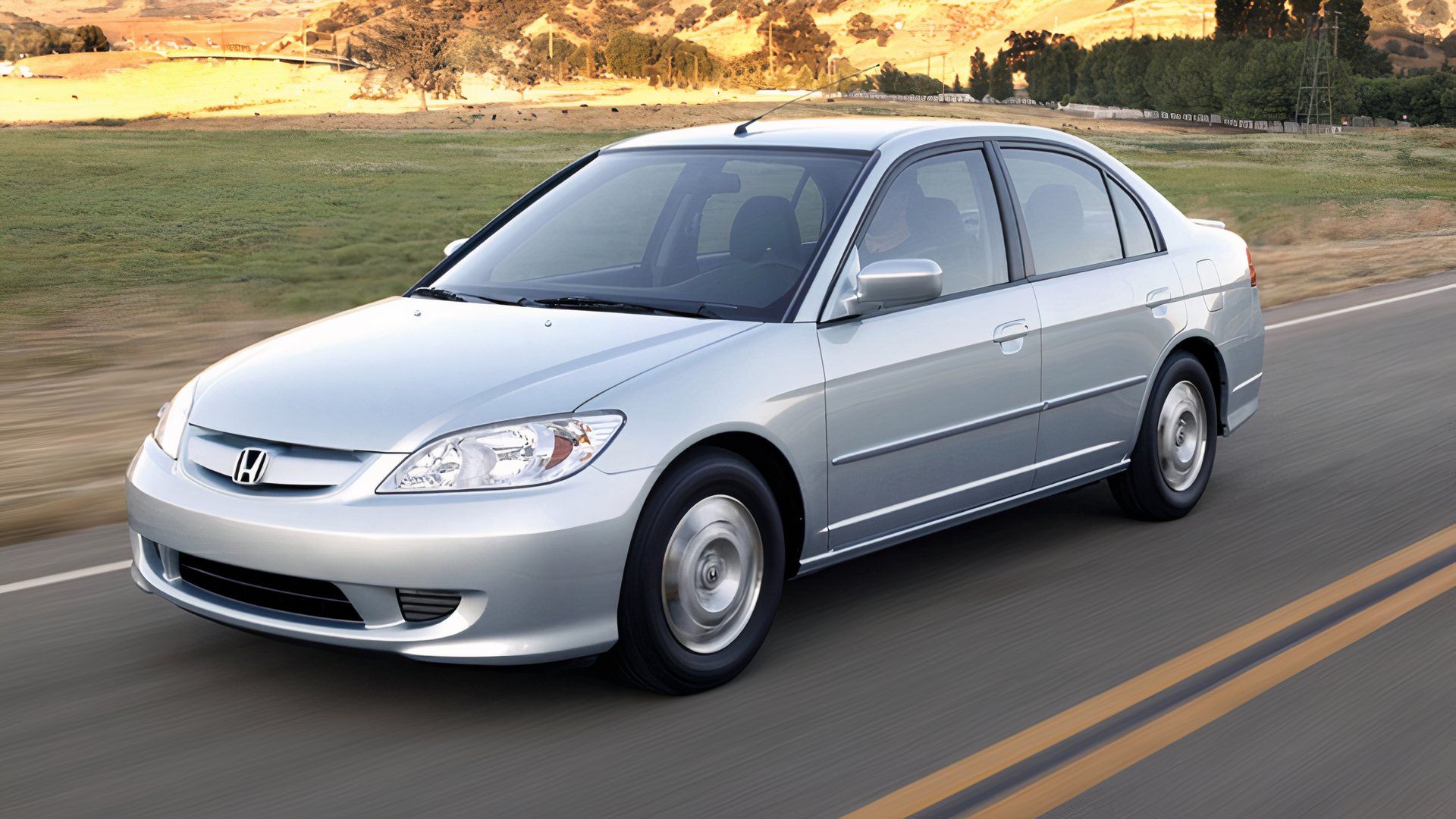 2003 Honda Civic Hybrid Sedan in silver Driving on road