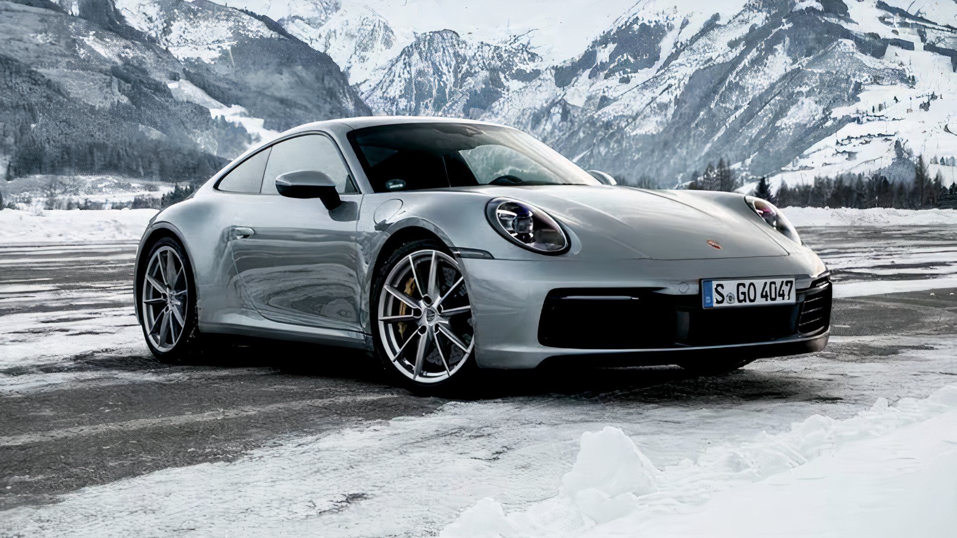 2024 Porsche 911 Carrera 4S In silver Posing on icy road in front of mountain range