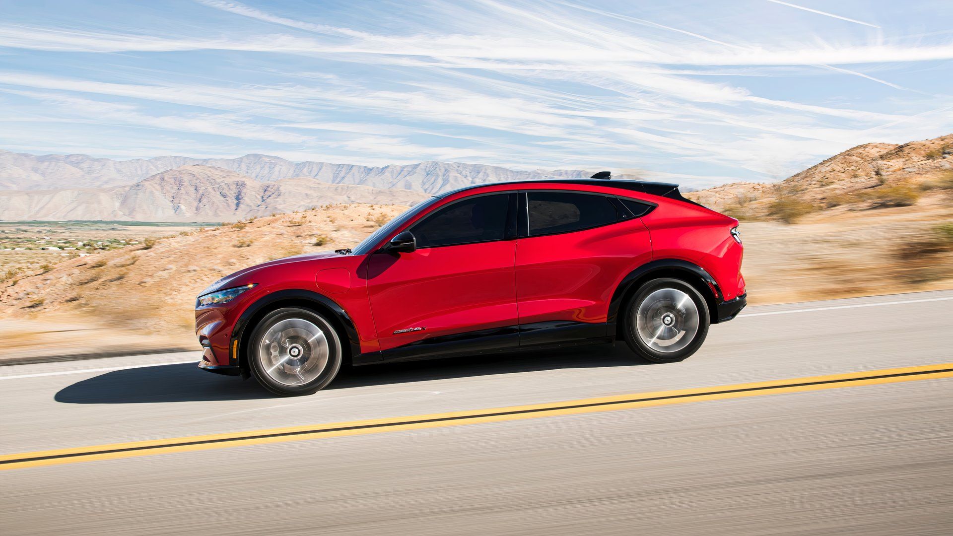 2021 Mustang Mach E side shot driving through the desert