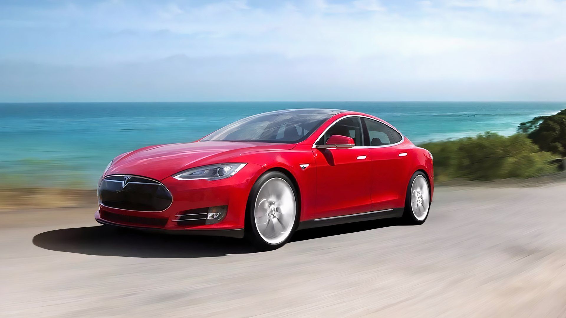 Um Tesla Model S vermelho de 2012 dirigindo