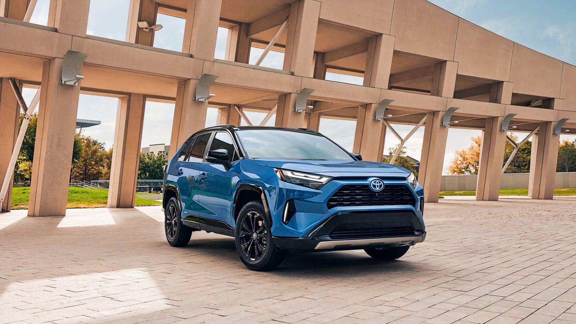 A blue small hybrid SUV Toyota RAV4 Hybrid 2024. 