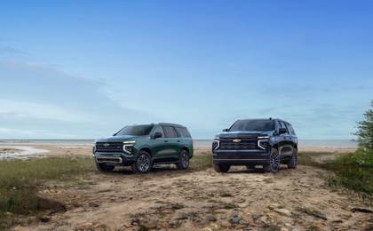 Front 3/4 shot of both the 2025 Chevrolet Tahoe and 2025 Chevrolet Suburban