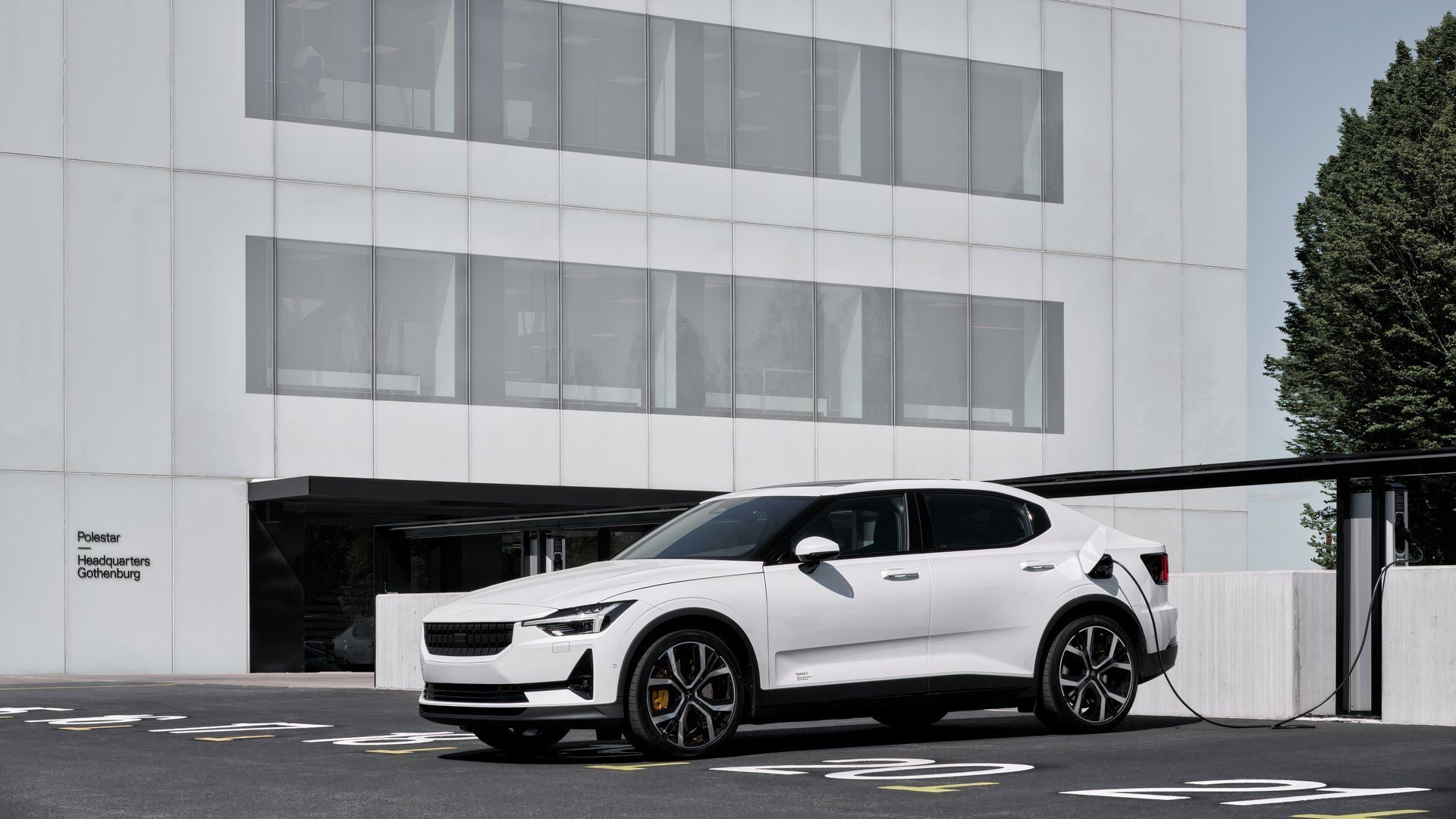 2021 Volvo Polestar 2 white plugged into a charging port