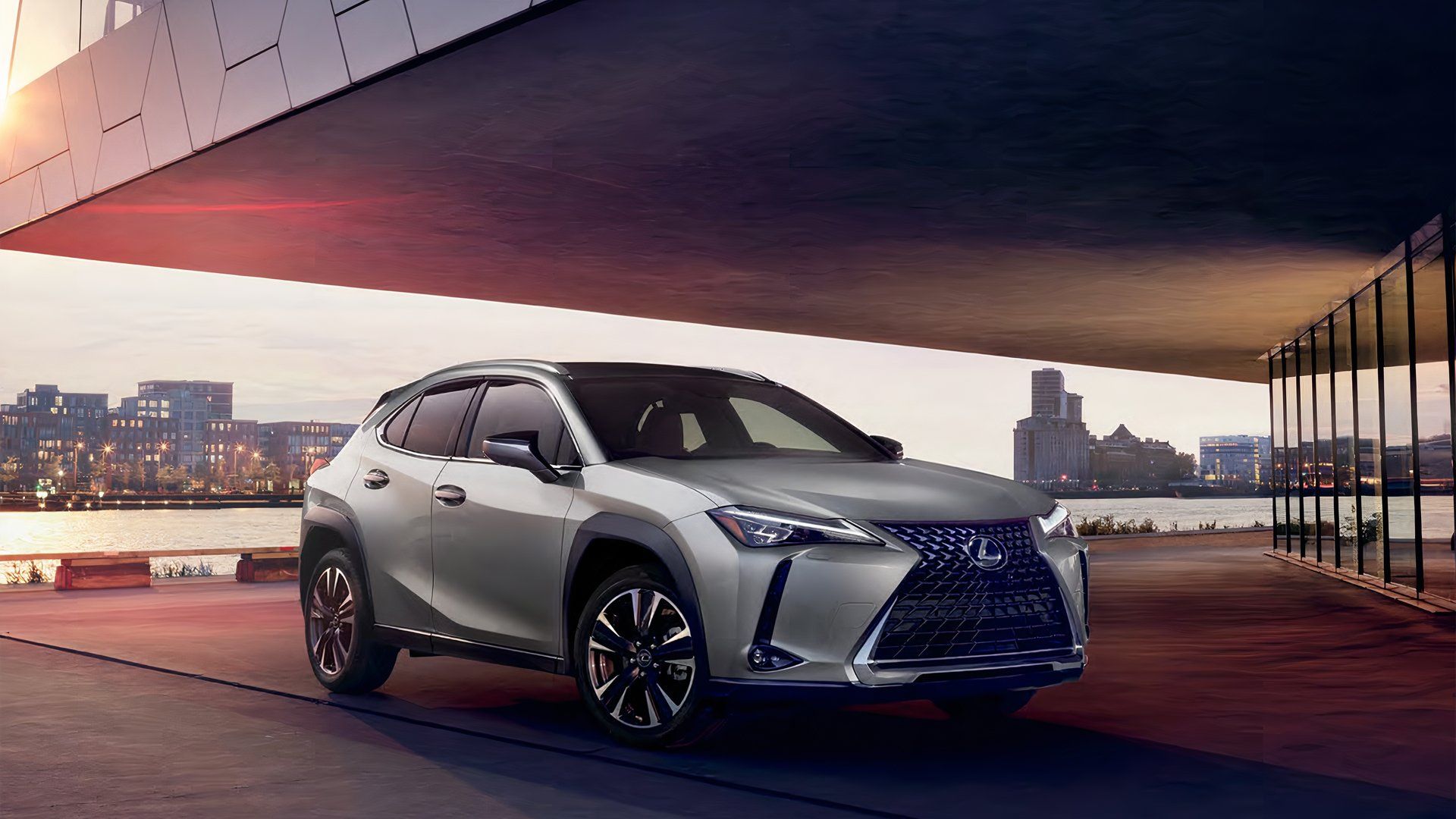 A 2021 Lexus UX in Atomic Silver parked under a building