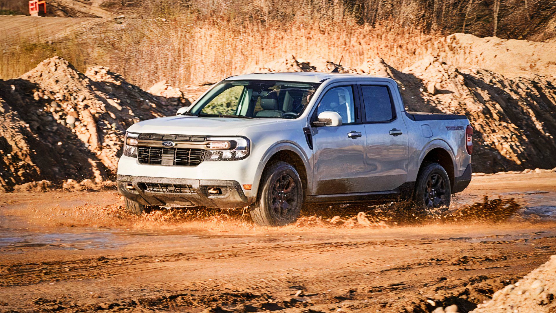 A Ford Maverick Hybrid drives off-road. 