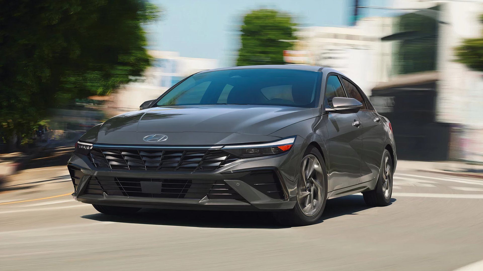 A gray Hyundai Elantra Hybrid is driving.