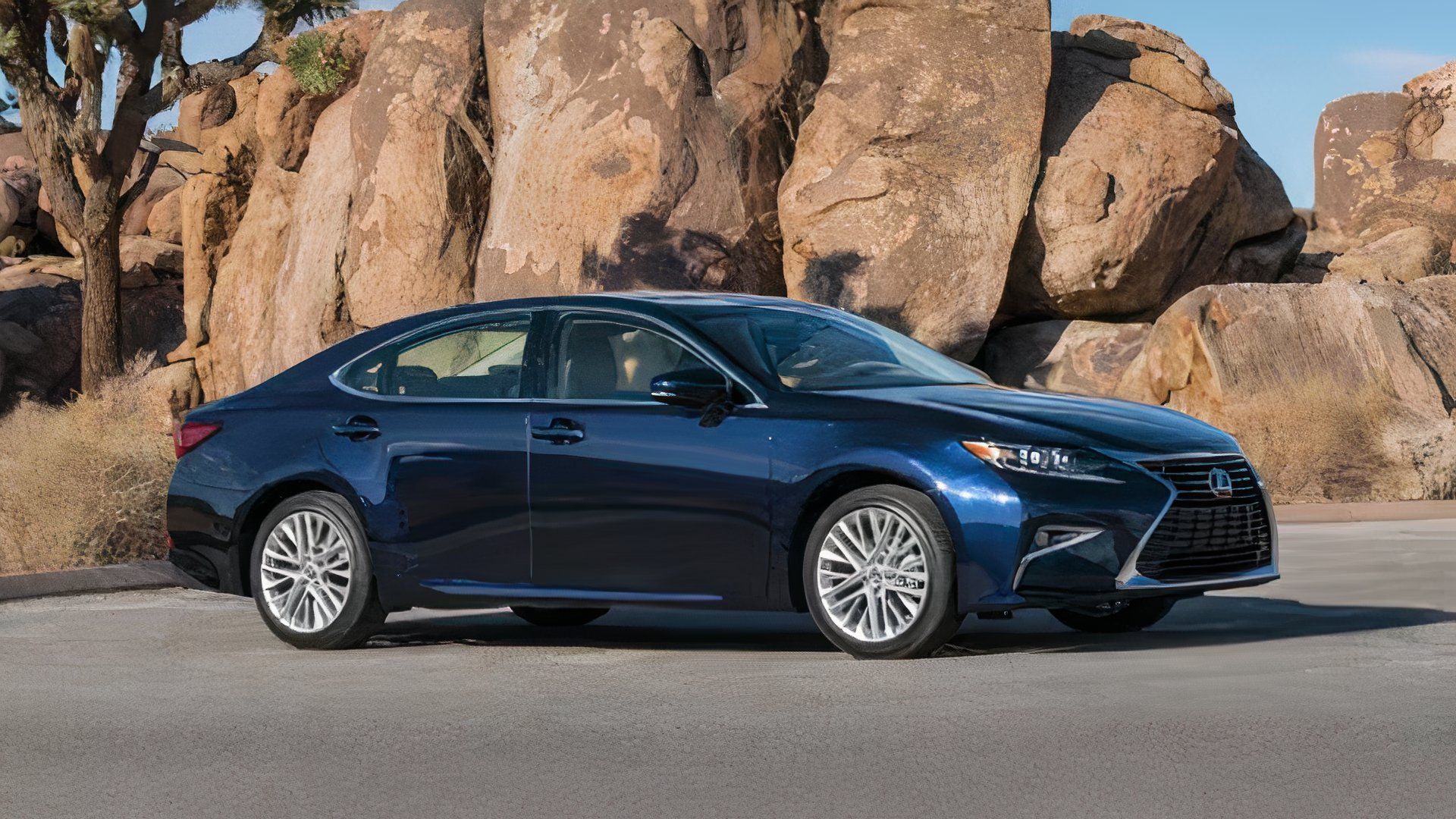 2018 Lexus ES in blue posing in front of rocks