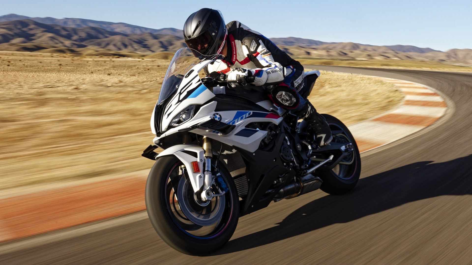 2024 BMW S1000RR on racetrack cornering front third quarter view