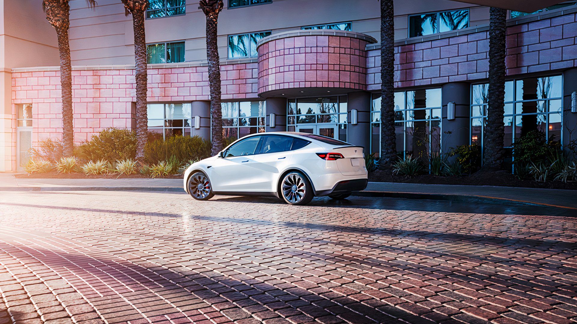A white Tesla Model Y is parked. 