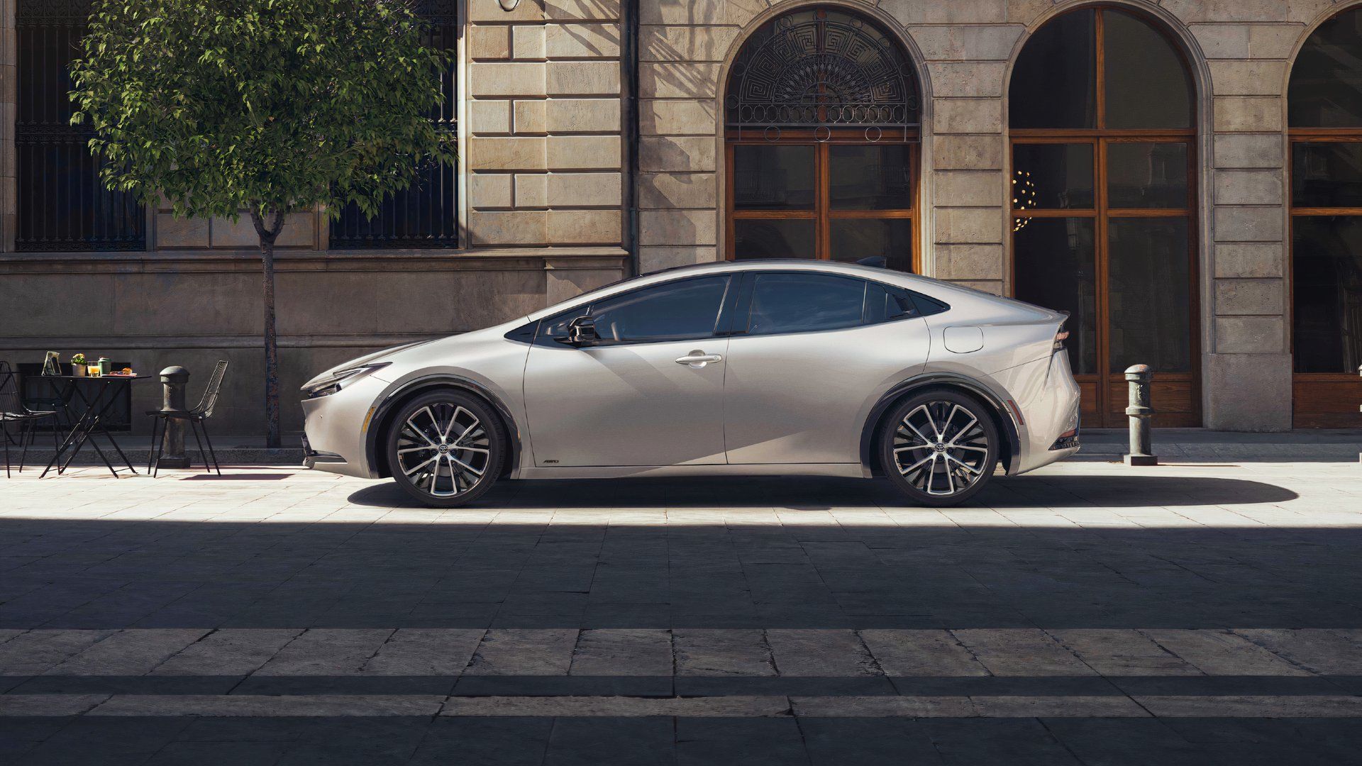 Side profile shot of a parked silver 2023 Toyota Prius.