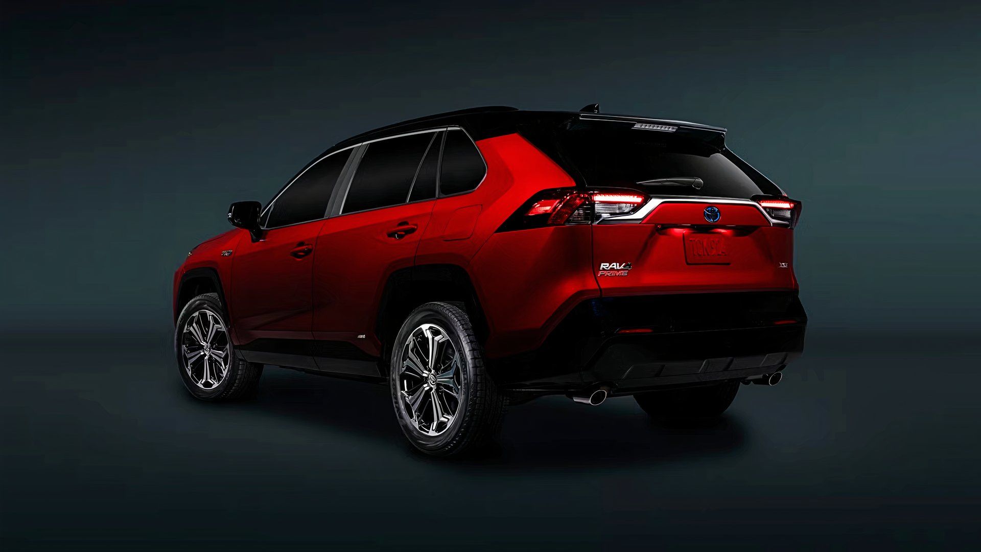 A red 2024 Toyota RAV4 Prime small plug-in hybrid SUV. 