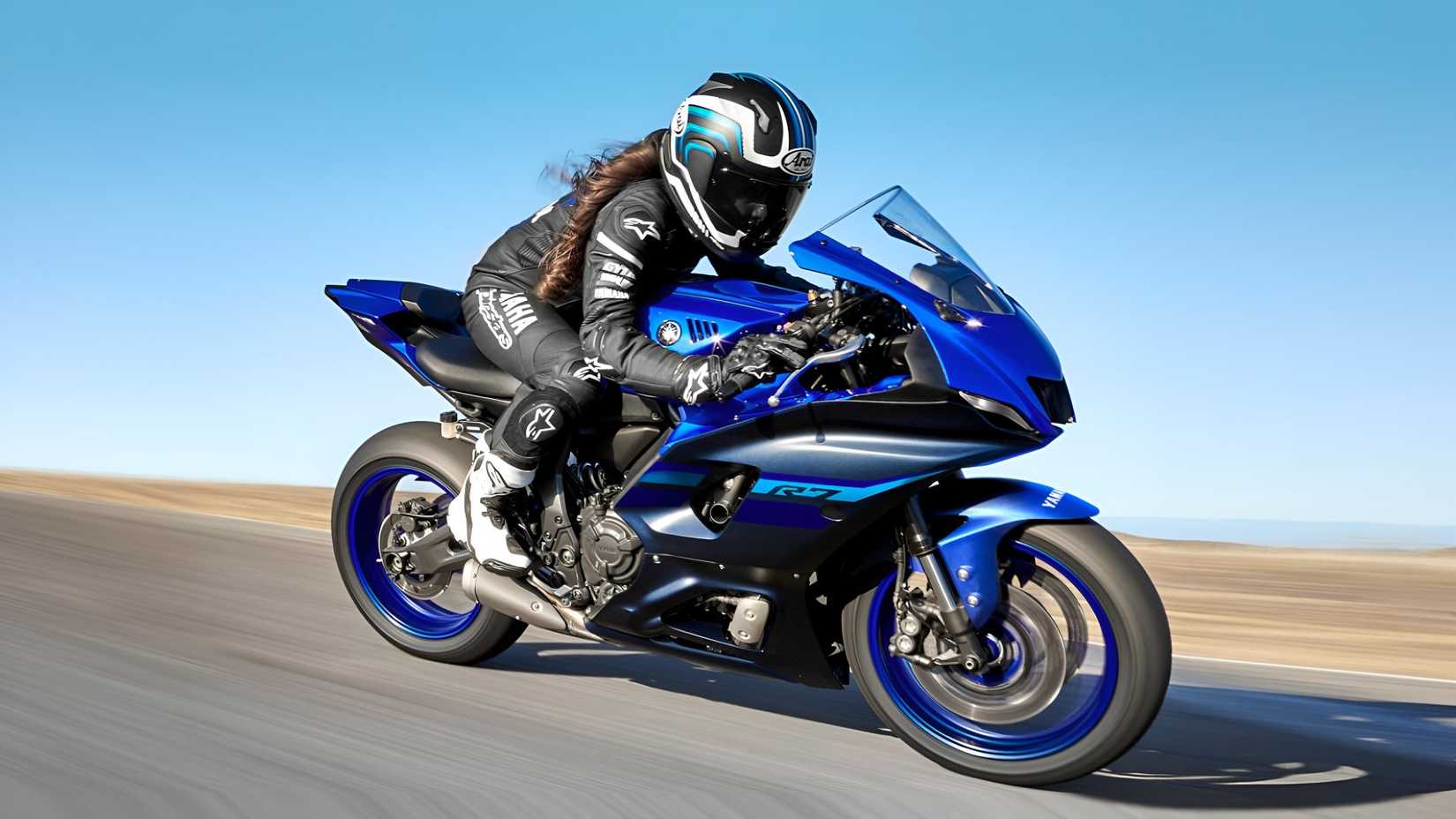2024 Yamaha YZF-R7 accelerating on a racetrack side profile view