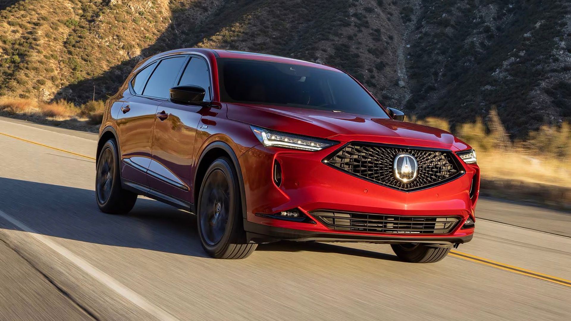 Um Acura MDX 2023 dirigindo por uma estrada de desfiladeiro