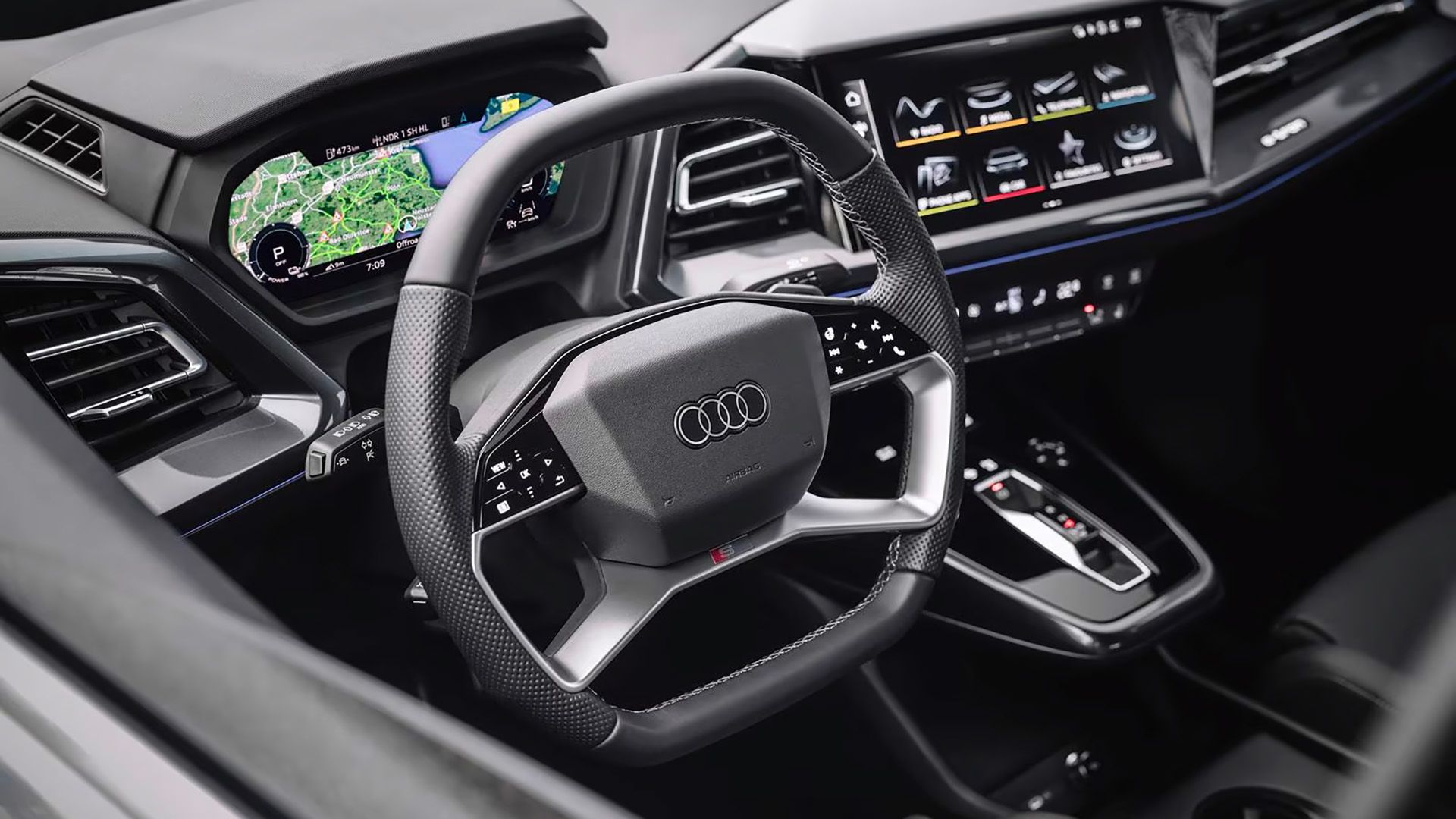 A close-up shot of the driver's side and steering in a 2023 Audi Q8 e-tron Sportback