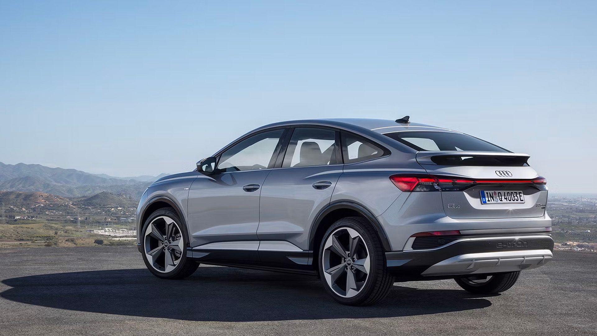 A rear, left hand-side three-quarter shot of a 2023 Audi Q4 e-tron Sportback