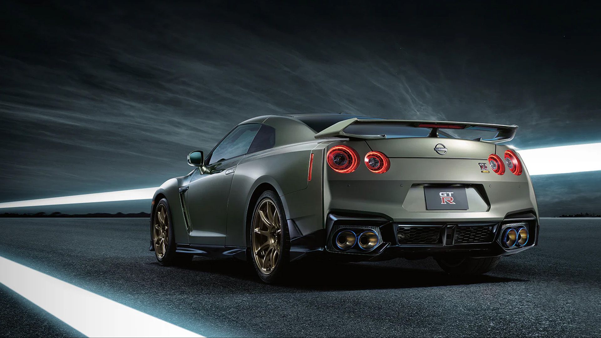 A rear, quarter shot of a 2024 Nissan GT-R about to speed down the road