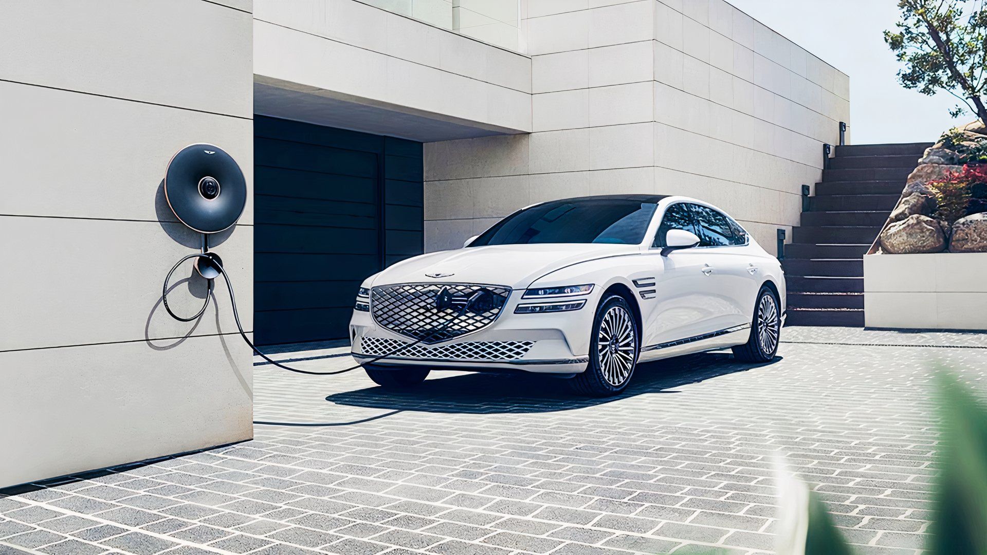 A white 2024 Genesis Electrified G80 electric sedan is parked. 