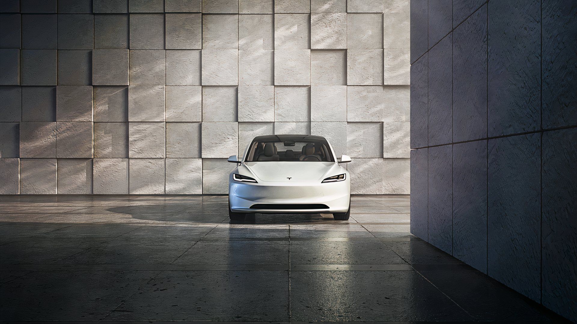 A white 2024 Tesla Model 3 electric sedan is parked. 