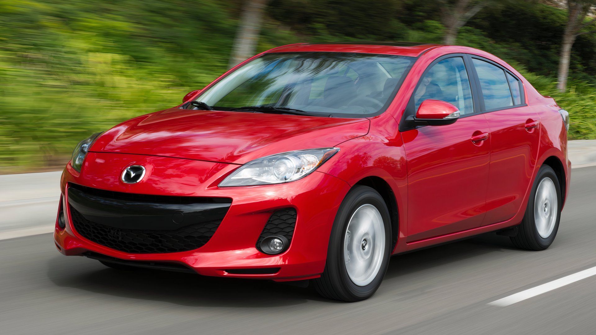 2013 Mazda3 driving down a road