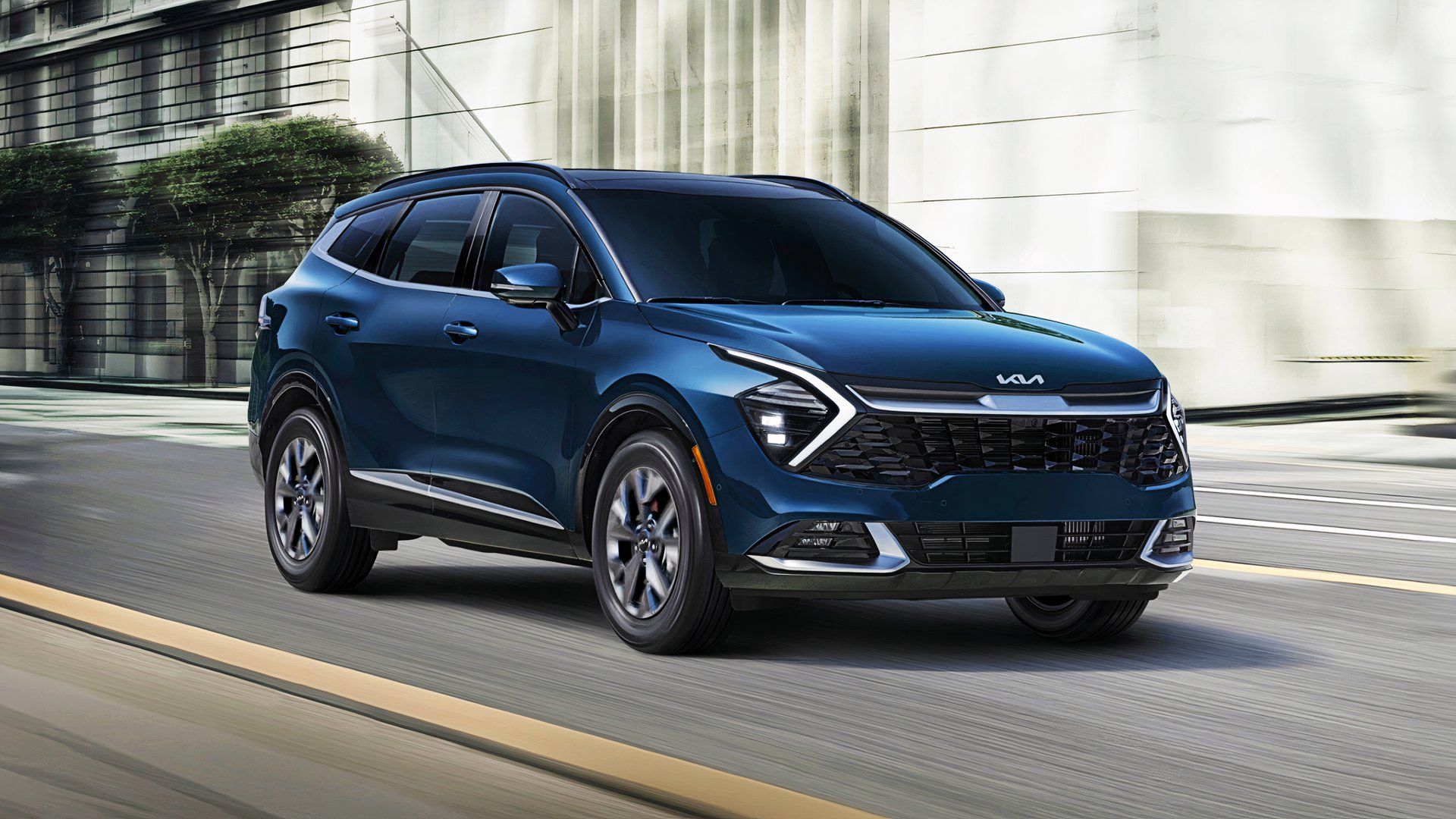 A blue 2025 Kia Sportage Hybrid small hybrid SUV is driving on the road. 