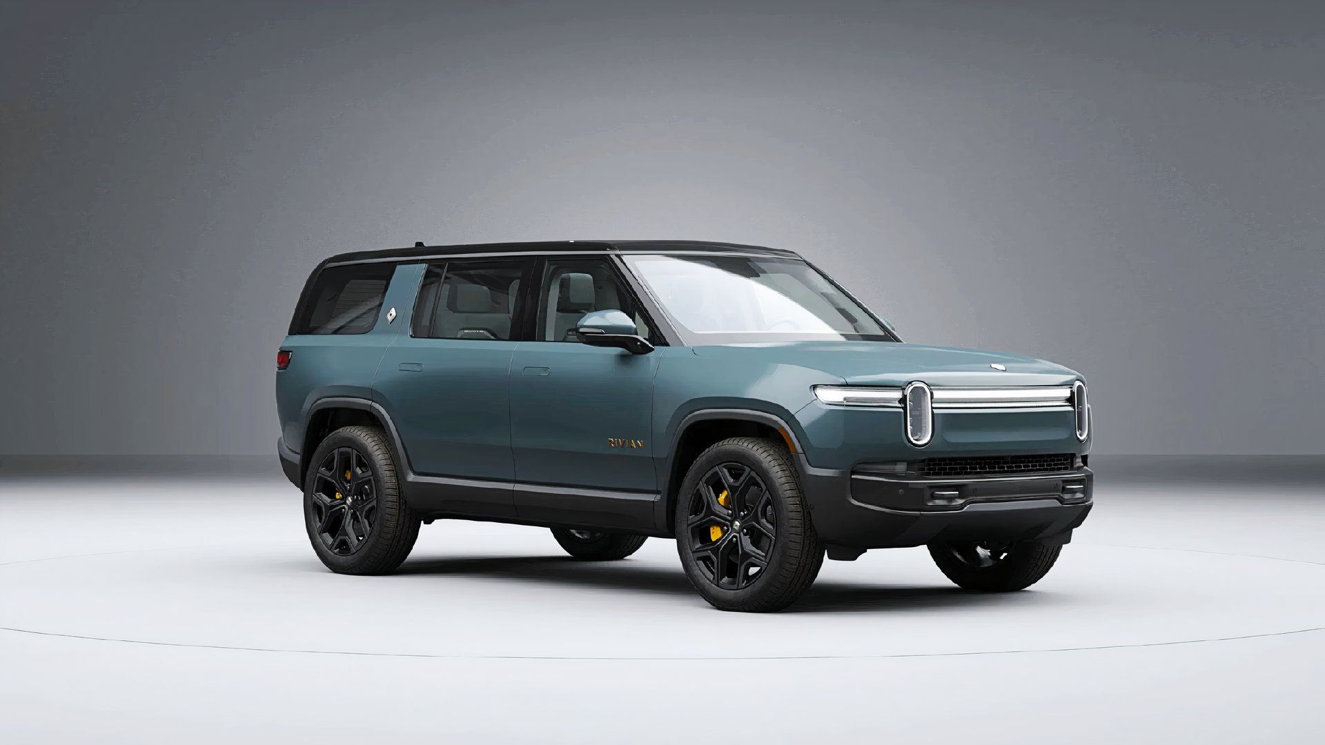 A blue 2025 Rivian R1S midsize electric SUV.