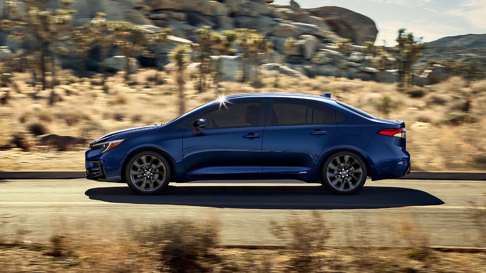Side profile shot of a blue 2025 Toyota Corolla Hybrid