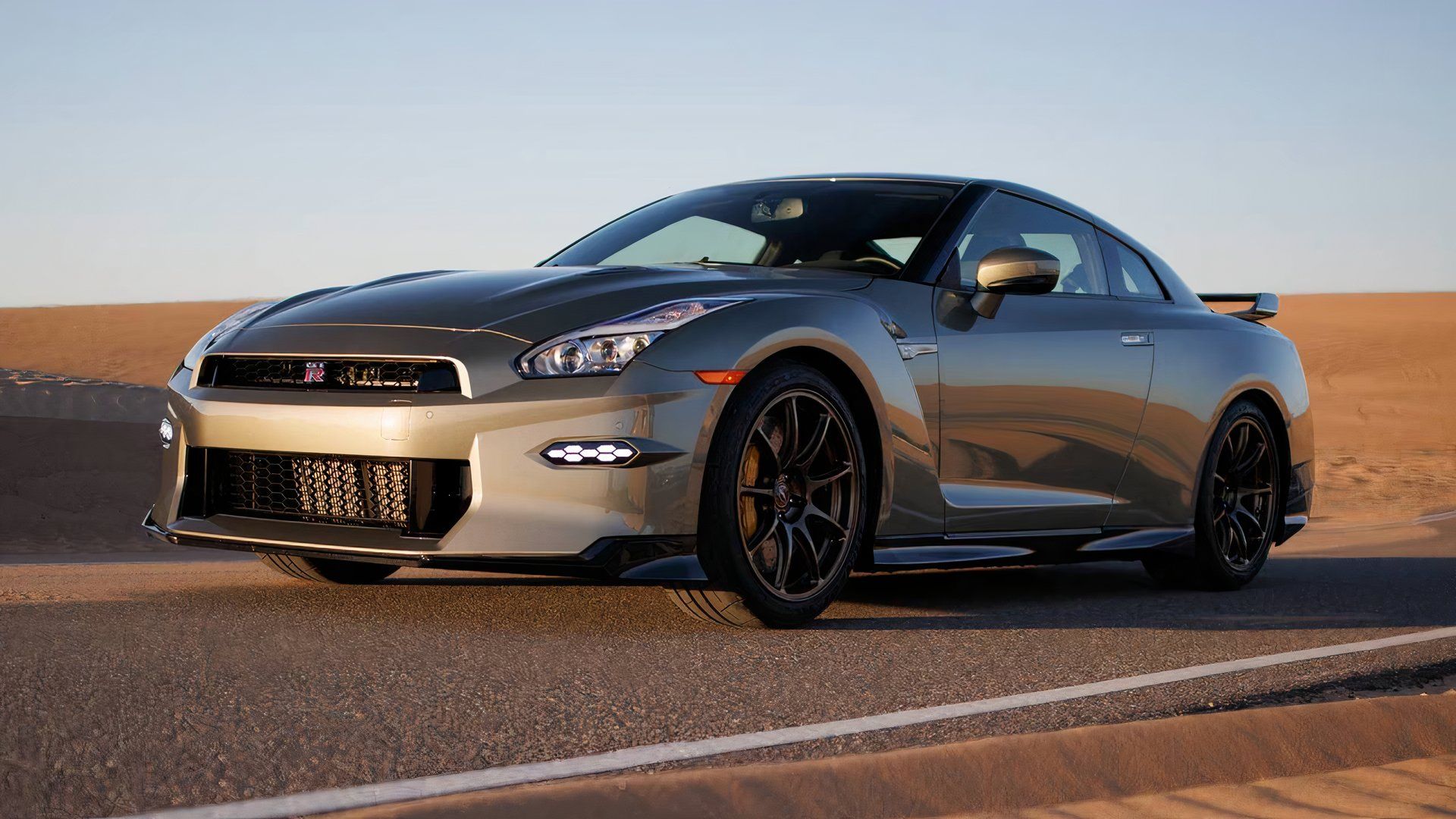 2024 Nissan GT-R T-Spec in silver driving on desert road